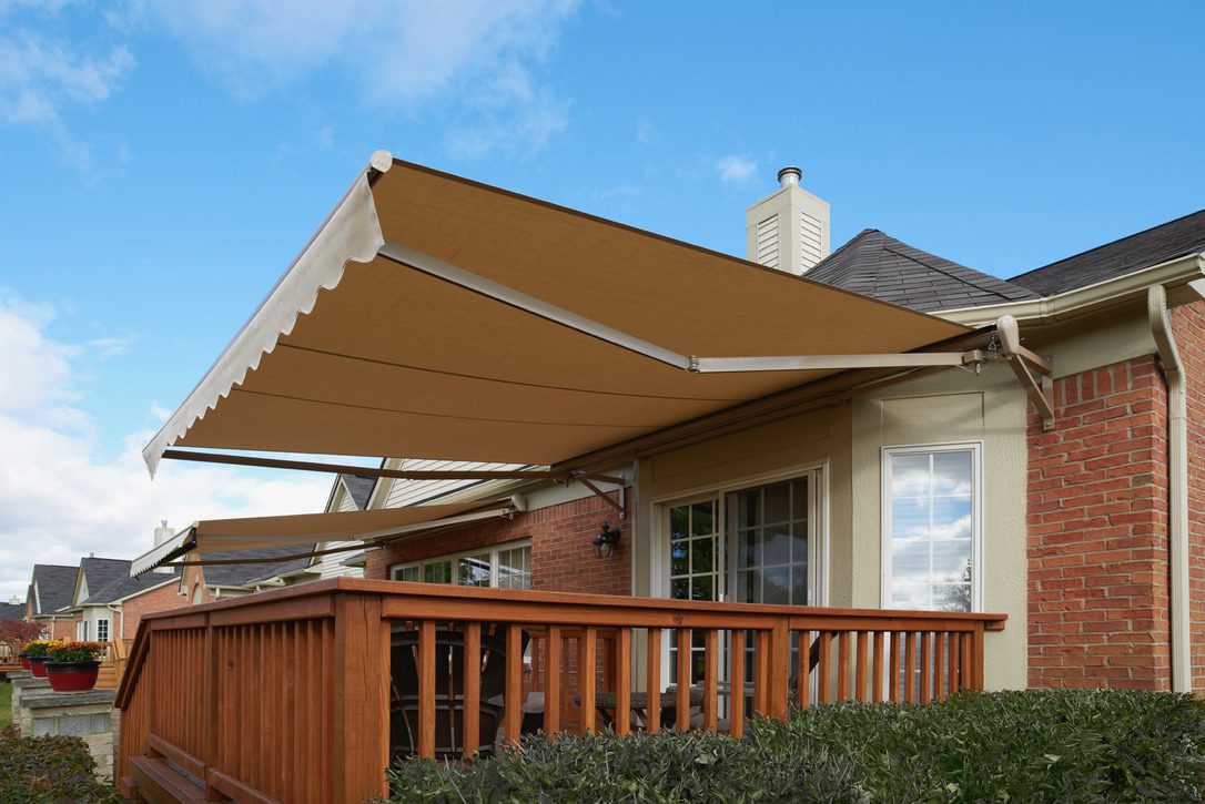 Retractable brown awning over home wooden deck