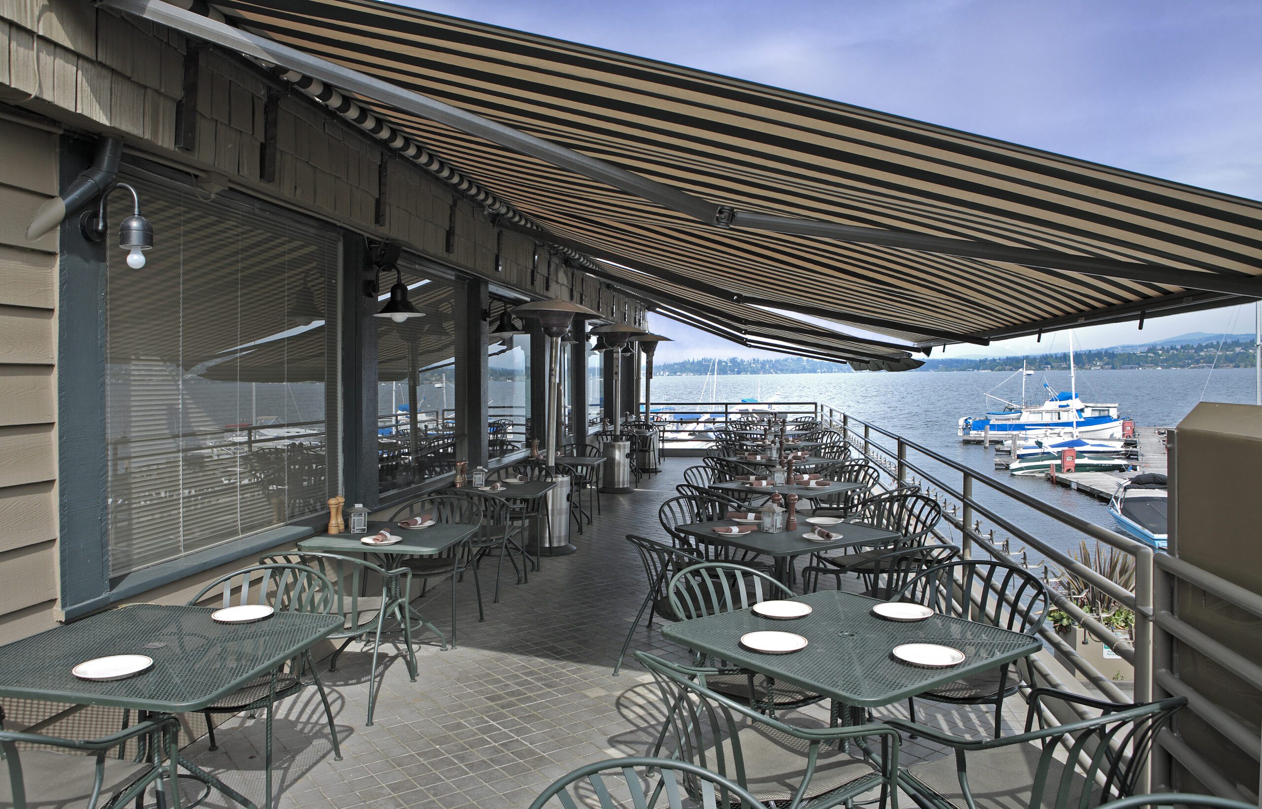 Empty lakeside restaurant patio overlooking boats