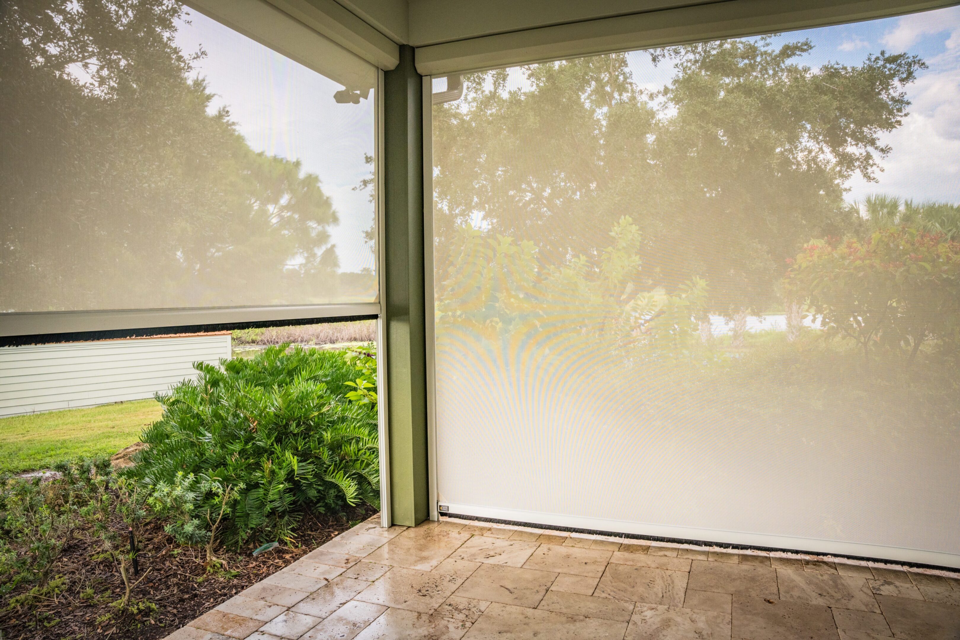 Tiled patio with retractable mesh privacy screens