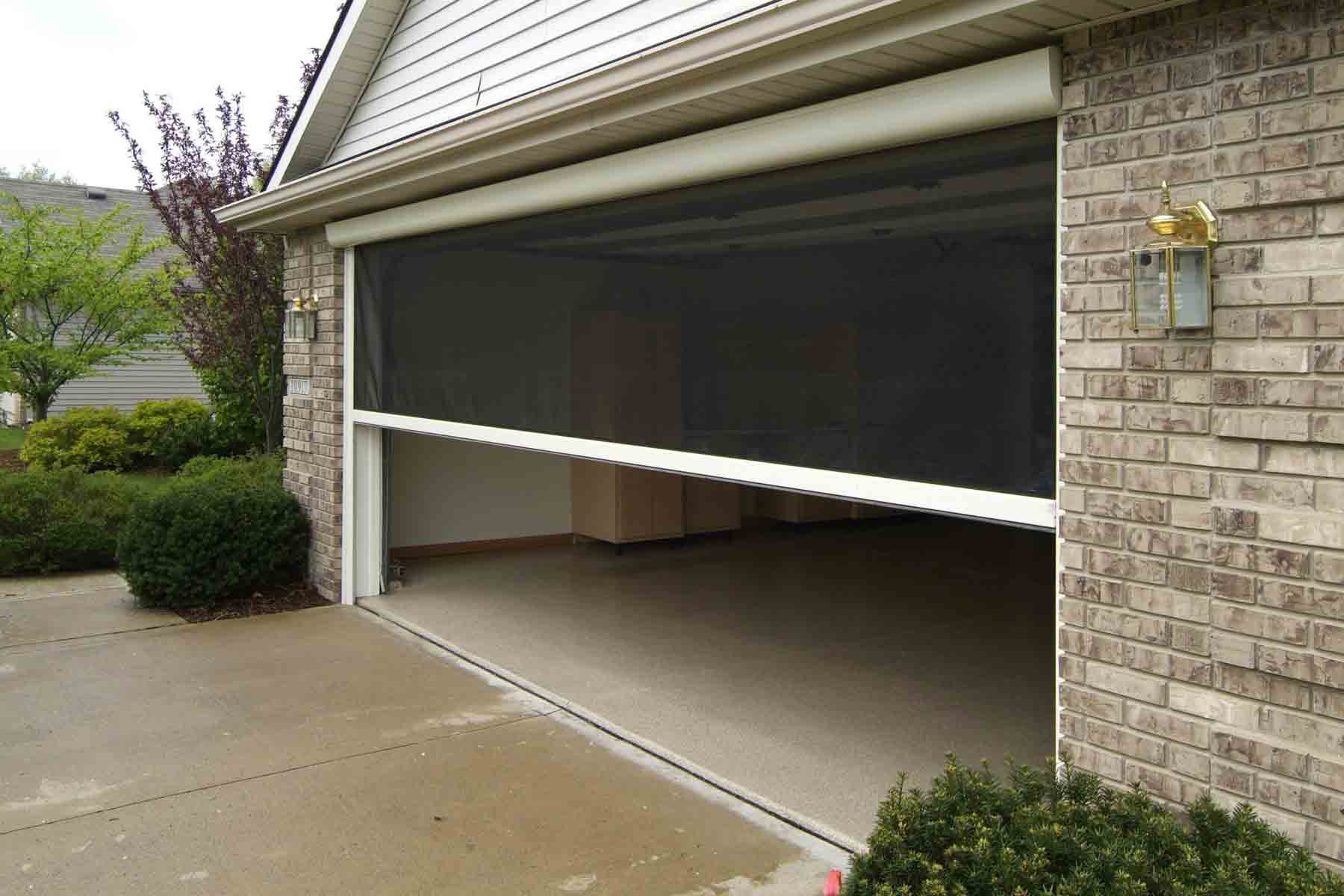 Residential garage with retractable screen door